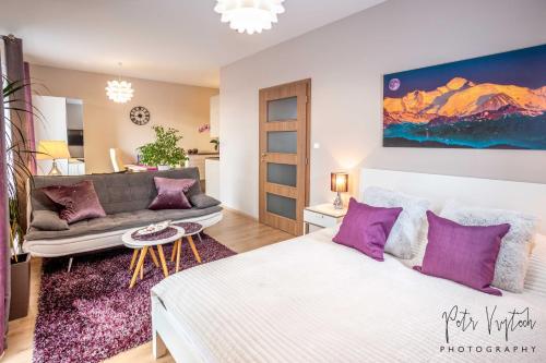 a living room with a bed and a couch at Luxurious, lovely and romantic apartment in Tabor in Tábor