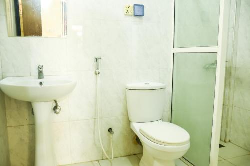 a bathroom with a toilet and a sink at Araliya Blue Beach View Hotel in Negombo