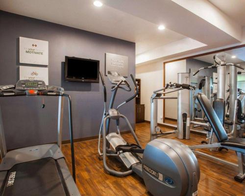 a gym with several tread machines and a tv at Comfort Suites Moses Lake in Moses Lake