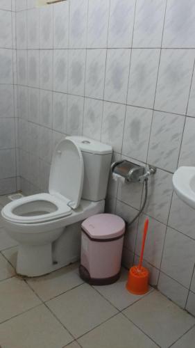 a bathroom with a toilet and a sink at Hotel Premier in Yumbe