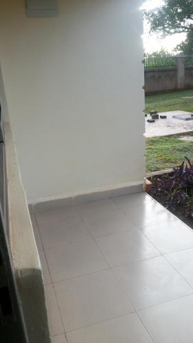 an open door to a patio with a tile floor at Hotel Premier in Yumbe