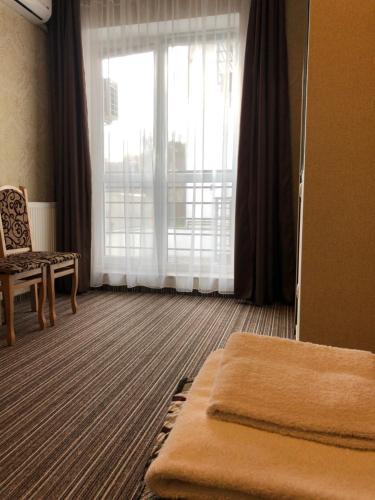 a hotel room with a bed and a large window at Motel Kurortnyy & SPA in Shklo