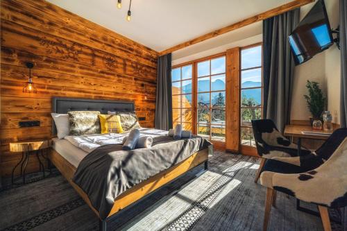 a bedroom with a bed in a room with wooden walls at Willa Szymaszkowa in Zakopane