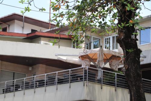 a building with an umbrella on a balcony at Mamba Point Hotel in Monrovia