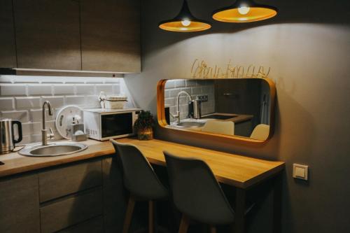 a kitchen with a counter with a sink and a mirror at Tedy's Apartments in New Gudauri in Gudauri