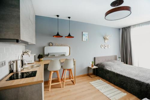 a small apartment with a bed and a kitchen with a sink at Tedy's Apartments in New Gudauri in Gudauri