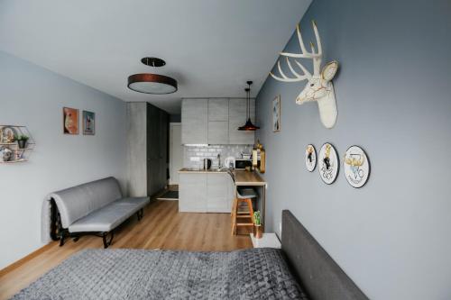 a living room with a bed and a kitchen at Tedy's Apartments in New Gudauri in Gudauri