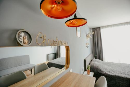 a room with a table and chairs and a mirror at Tedy's Apartments in New Gudauri in Gudauri