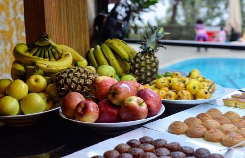 a table topped with plates of fruits and vegetables at Symbola Oludeniz Beach Hotel in Oludeniz