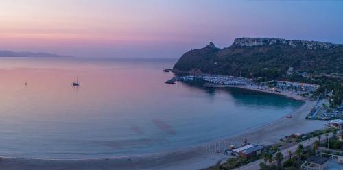 an aerial view of a beach at sunset at Le Palmette Suites in Cagliari