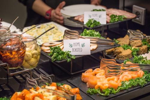 a buffet with many different types of food on display at Andersia Hotel & Spa Poznan, a member of Radisson Individuals in Poznań