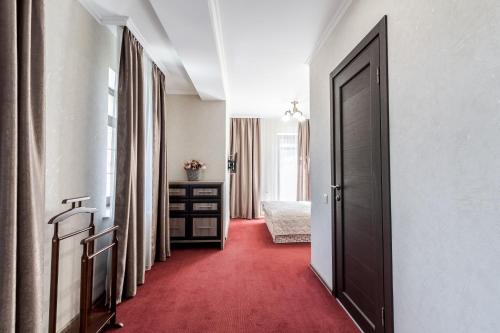 a corridor of a hotel room with a red carpet at Villa Gor Apartments in Bukovel