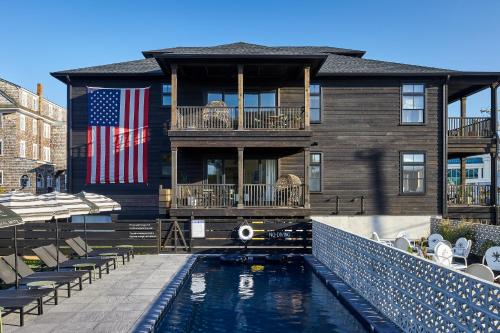 a house with a swimming pool in front of a house at Lokal Hotel Cape May in Cape May