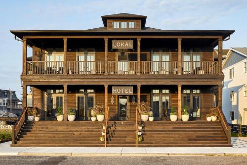 a large wooden building with a hotel sign on it at Lokal Hotel Cape May in Cape May