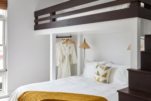 a bedroom with a large white bed with a dresser at Lokal Hotel Cape May in Cape May