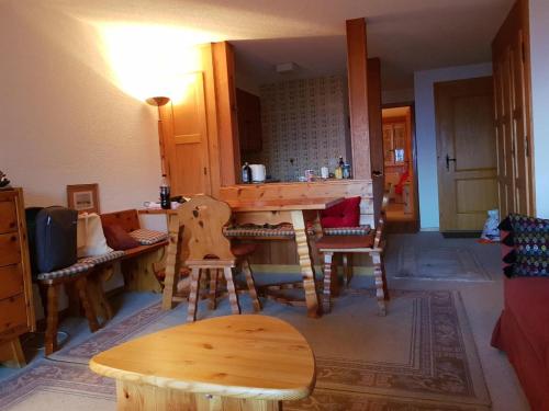 a kitchen with a table and chairs in a room at Le Grammont 9 in Villars-sur-Ollon