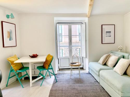 a living room with a couch and a table at Apartments Center Santos in Lisbon