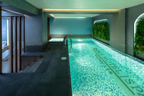 a swimming pool in a room with a bathroom at Danis Hotel Istanbul Old City in Istanbul