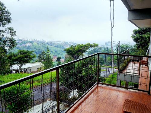 a balcony with a view of a mountain at The Wiltshire Dago Pakar - Hillside Villa MAX 12 ORANG in Bandung