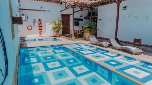 a swimming pool with chairs in a house at Misia Custodia Hotel Boutique in Barichara