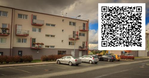 a group of cars parked in a parking lot next to a building at Luxurious, lovely and romantic apartment in Tabor in Tábor