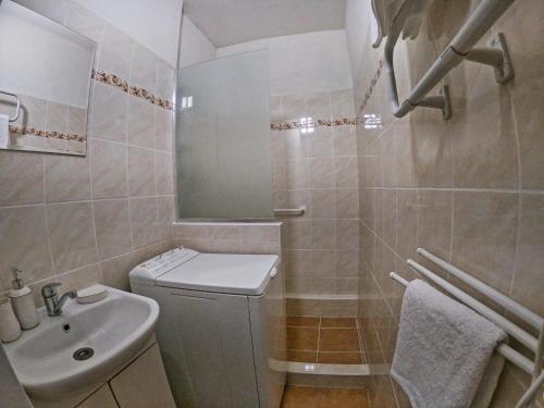 a bathroom with a sink and a toilet and a mirror at Apartman Breza in Tatranská Polianka