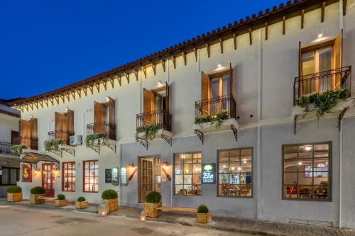 a facade of a building with windows and plants at Kastalia Boutique Hotel in Delfoi