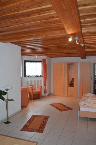 a living room with a wooden ceiling and a living room at Hotel Restaurant Waldschlössel in Speyerbrunn