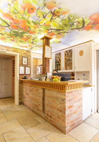 a kitchen with a counter with a painting on the ceiling at Hotel Restaurant Mühlenhof Bosse in Dachwig