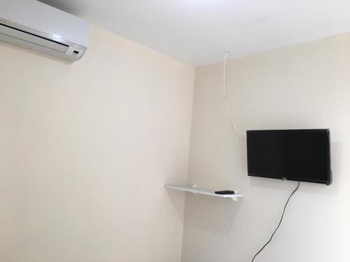 Televízia a/alebo spoločenská miestnosť v ubytovaní Pousada Alto de Junqueira