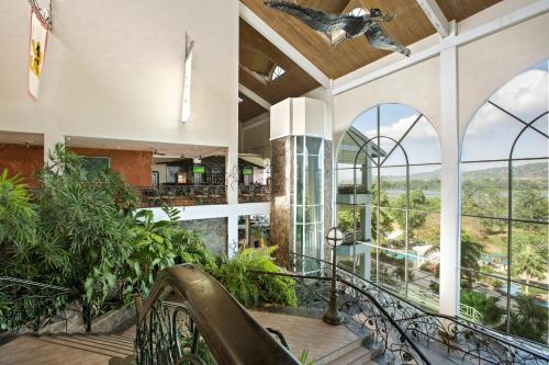 an indoor lobby with a staircase with a bird on the ceiling at Gamboa Rainforest Reserve in Gamboa