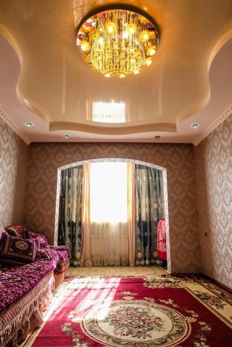 a living room with a chandelier and a couch at Quiet appartment in Bishkek city in Bishkek