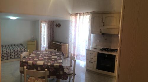 eine Küche mit einem Tisch und eine Küche mit einem Herd in der Unterkunft Casa Calanave 2 in Ventotene