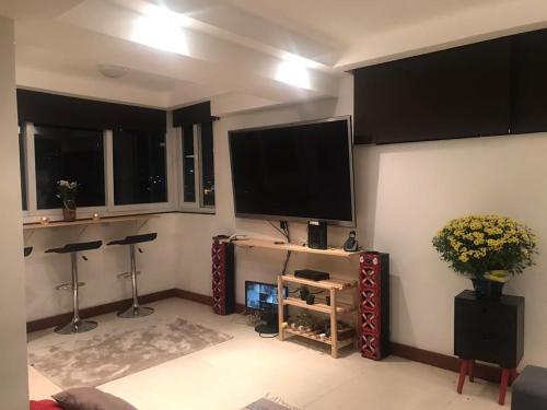a living room with a flat screen tv on the wall at Laguna Hostel in Rio de Janeiro
