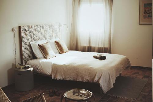 a bedroom with a large bed with a window at Domaine de Carraire in Aix-en-Provence