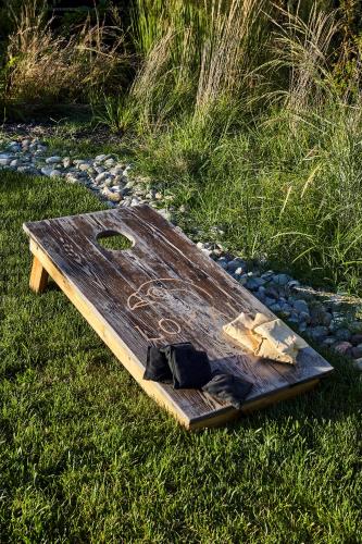 a wooden cutting board sitting on the grass at Lokal Hotel Cape May in Cape May