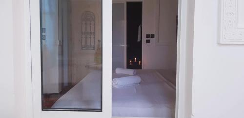 two views of a bathroom through a door at Riad Bleu Afriqua in Boumalne