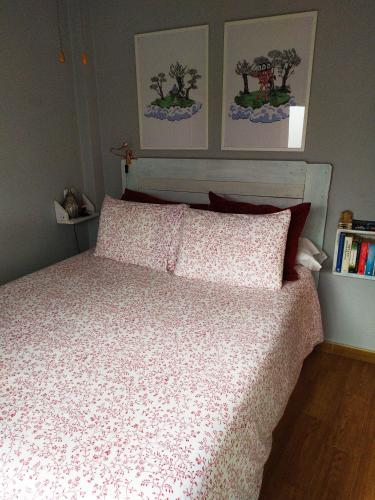 a bedroom with a bed with a white comforter at Apartamento La Peatonal in San Sebastián de la Gomera