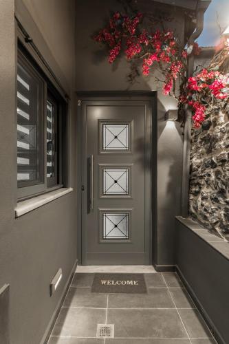 a front door with flowers on the wall at THESS OLD TOWN 2 free private parking of stayinthess in Thessaloniki