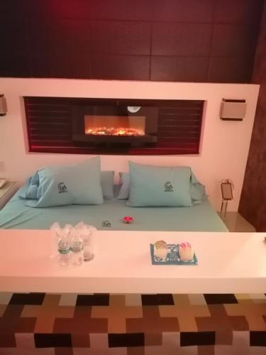 a room with a bed with a fireplace at Hotel Lua in Mexico City