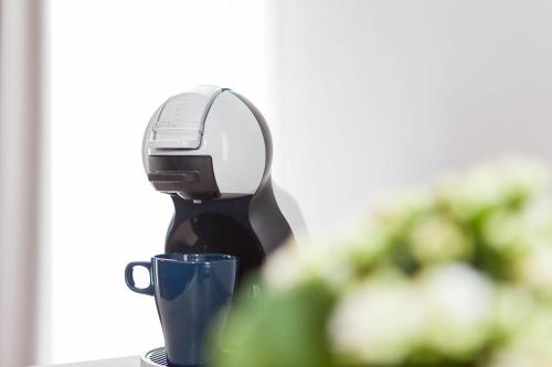 a hair dryer sitting on a table with a cup at Stadtrandzimmer in Herrnburg