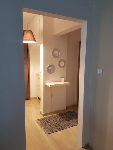 a hallway with a sink and a table in a room at Fenia's Apartment in Thessaloniki