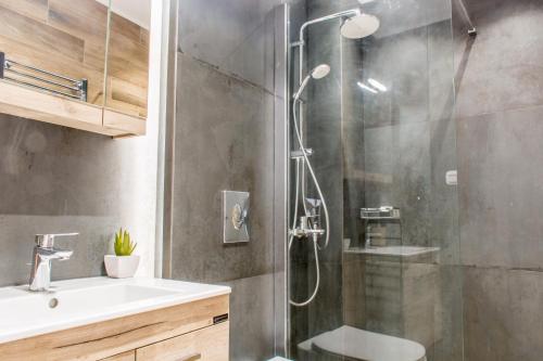 a bathroom with a shower with a sink and a toilet at Rene Luxury Home in Zakynthos Town