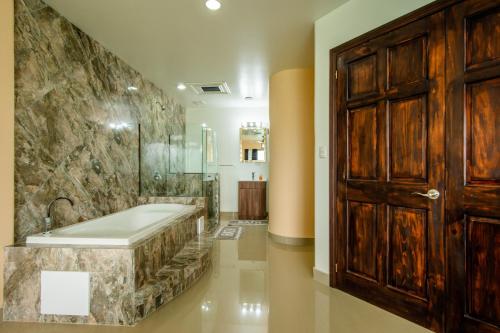 a large bathroom with a tub and a shower at Lake Arenal Condos in Naranjos Agrios