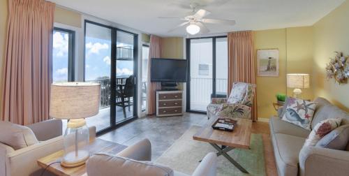 a living room with a couch and a tv at Seaside 5414 Condo in Orange Beach