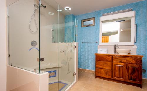 a bathroom with a shower and a sink at Lake Arenal Condos in Naranjos Agrios