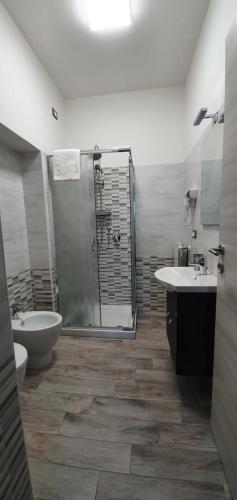 a bathroom with a shower and a toilet and a sink at Castelvecchio B&B in Sorano