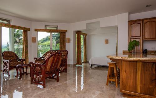 a living room with a bed and a table and chairs at Lake Arenal Condos in Naranjos Agrios