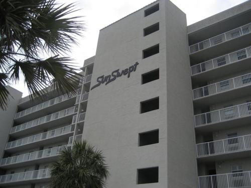 a building with a sign on the side of it at Sunswept 703 Condo in Orange Beach