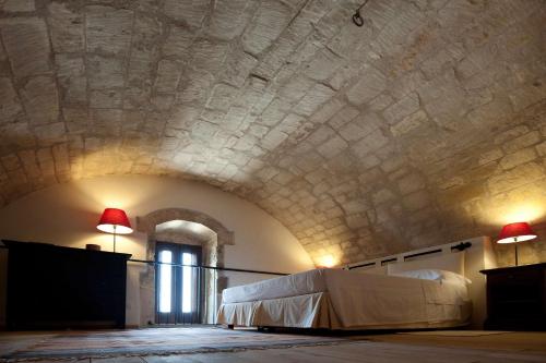a room with a bed and a ceiling with red lamps at La Dimora di Spartivento - BW Signature Collection in Ragusa